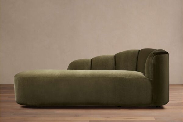 Amira Daybed in olive green fabric, featuring a low-profile design with a smooth, rounded backrest and no visible legs, on a wooden floor.